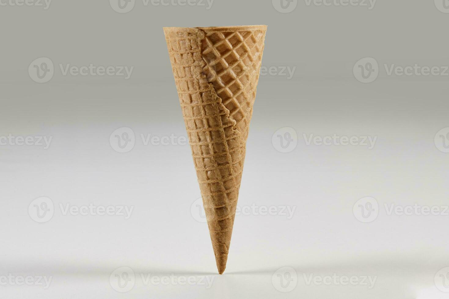 Empty, big wafer cone for ice cream isolated on white. Concept of food, treats. Mockup, template for your advertising and design. Close up photo