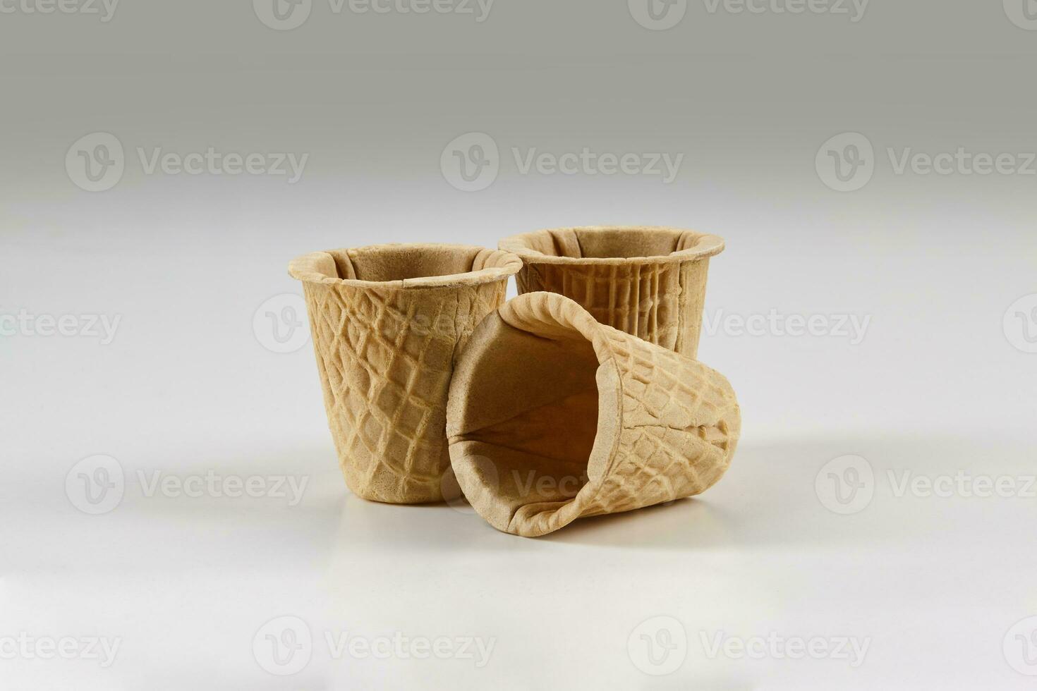 Three empty wafer cups for ice cream isolated on white background. Concept of food, treats. Mockup, template for your advertising and design. Close up photo