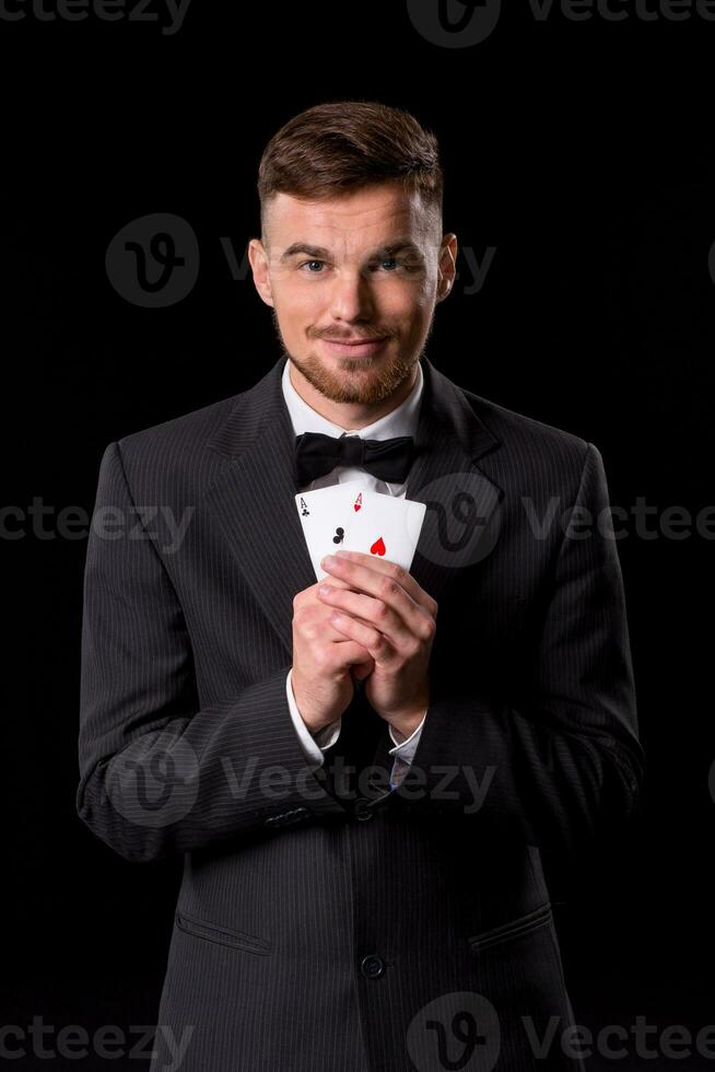 man in a suit posing with cards photo