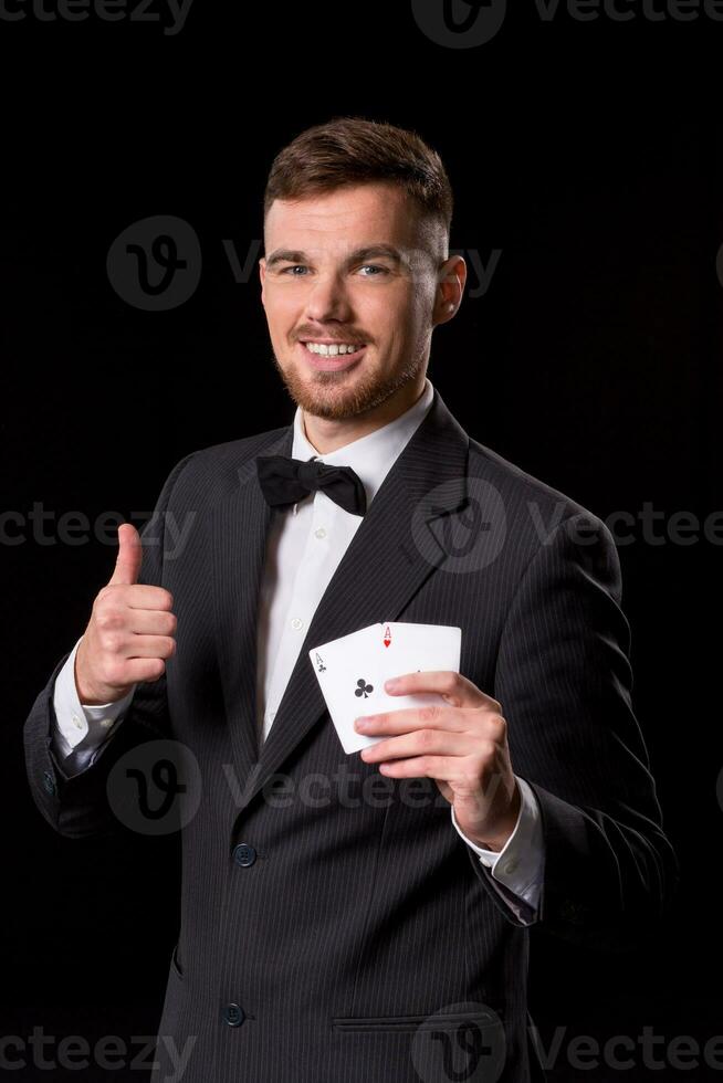 man in a suit posing with cards photo