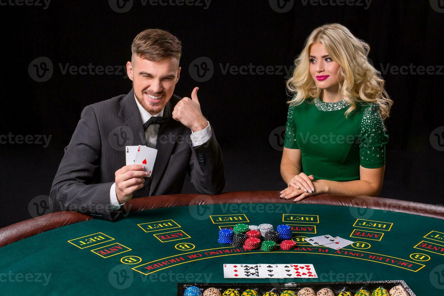 couple playing poker at the table. photo