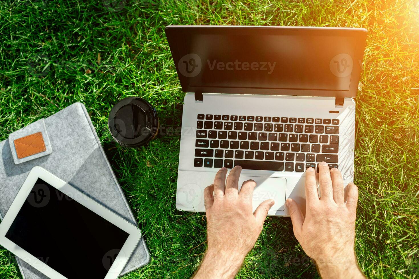 Close-up shot of handsome man's hands touching laptop computer's screen. photo