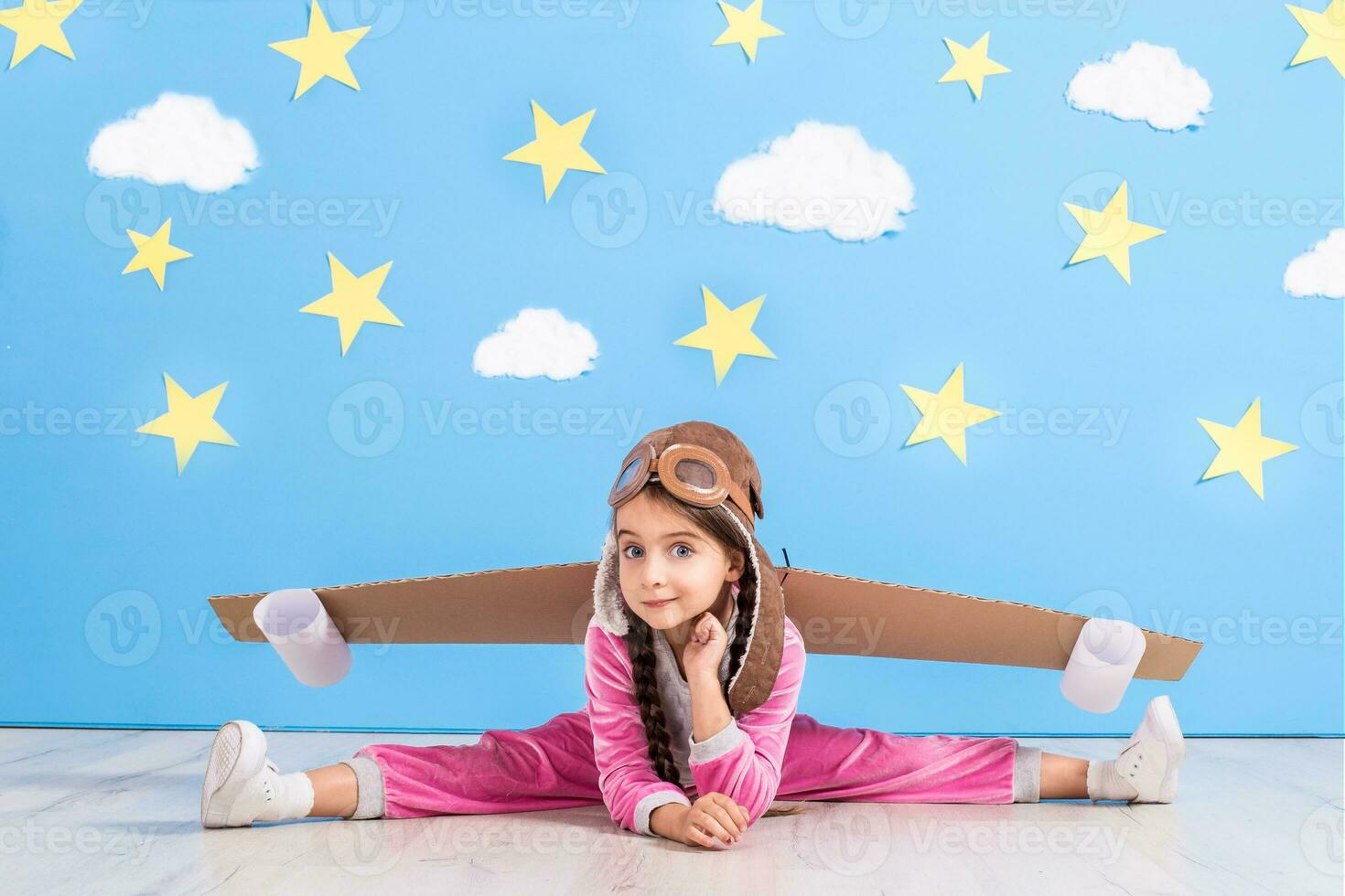 Girl pilot playing with toy jet pack at home. Success and leader concept photo