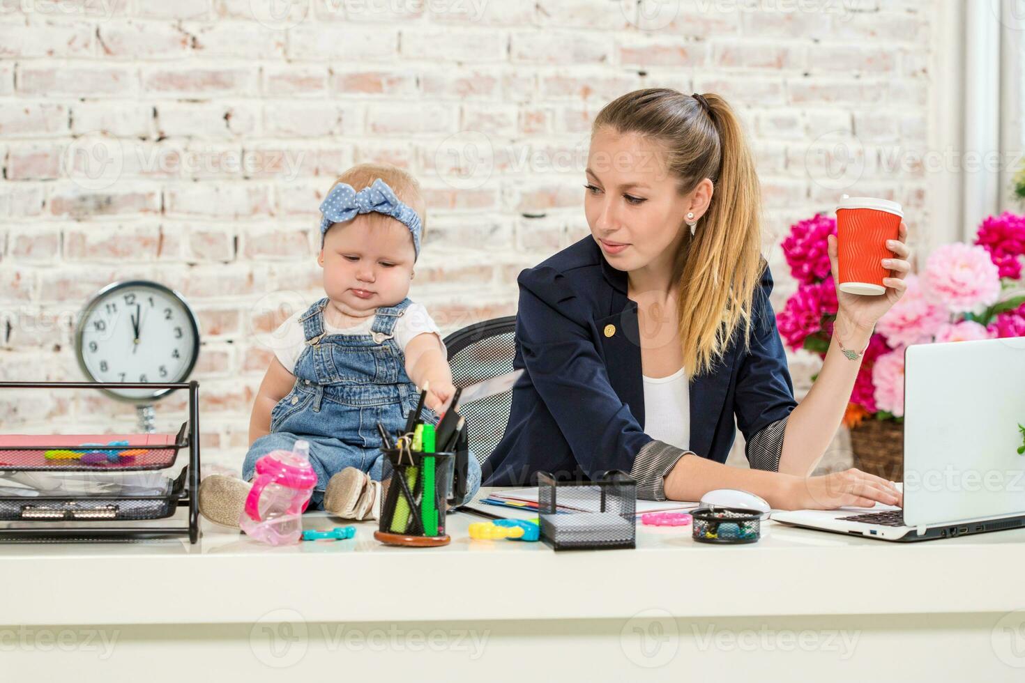 Businesswoman mother woman with a daughter working at the laptop photo