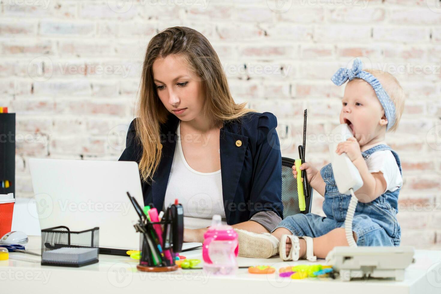 Businesswoman mother woman with a daughter working at the computer photo