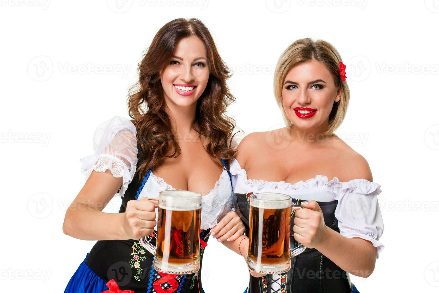 Two beautiful blond and brunette girls of oktoberfest beer stein photo