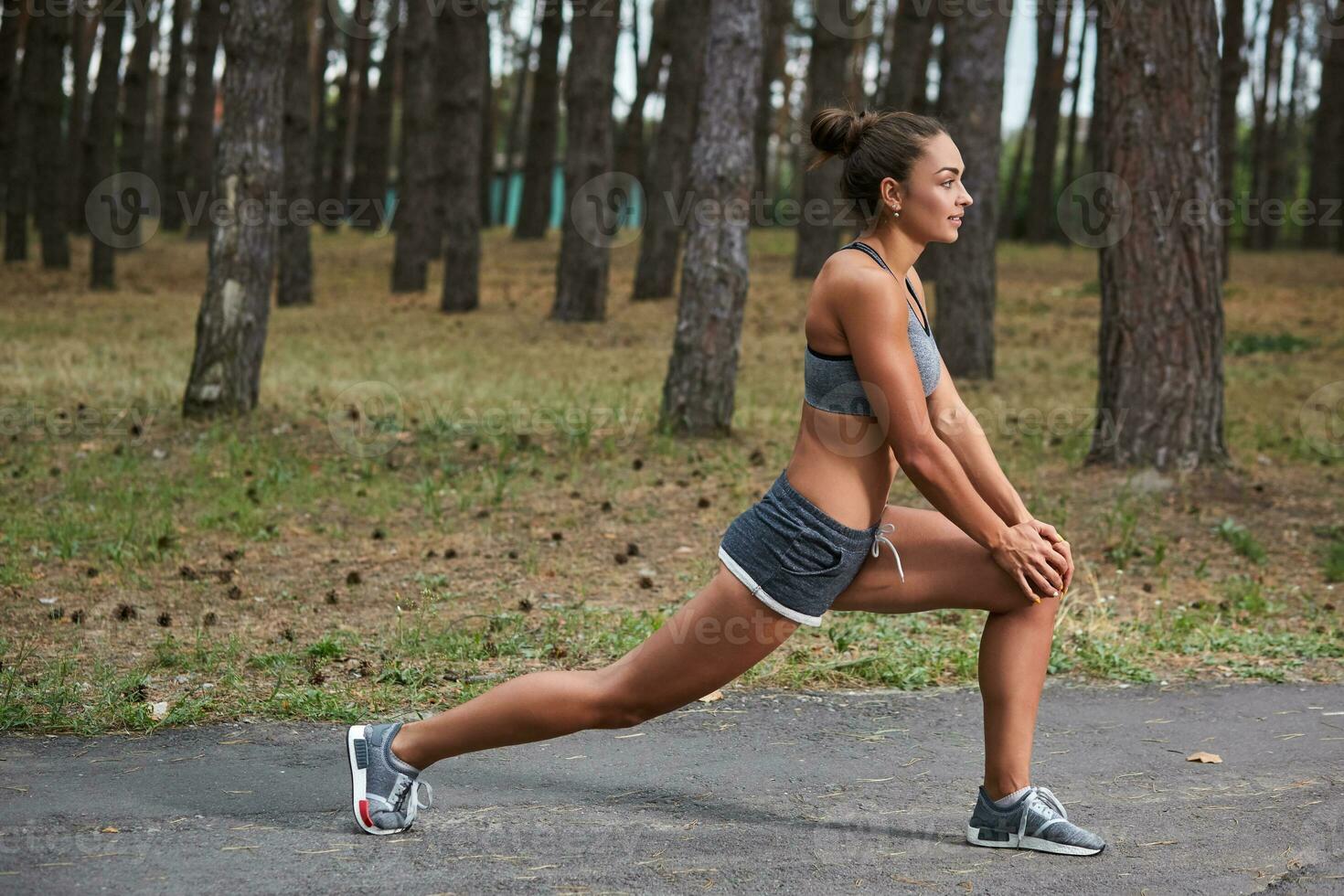 Young woman running outdoors in a city park photo