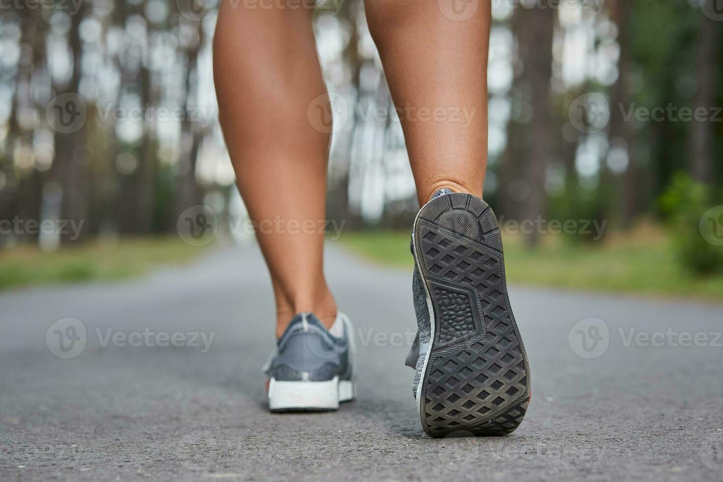 Young woman running outdoors in a city park photo