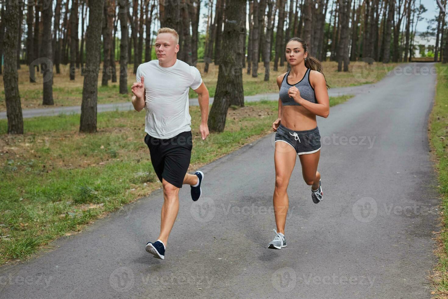 Couple running in forest photo