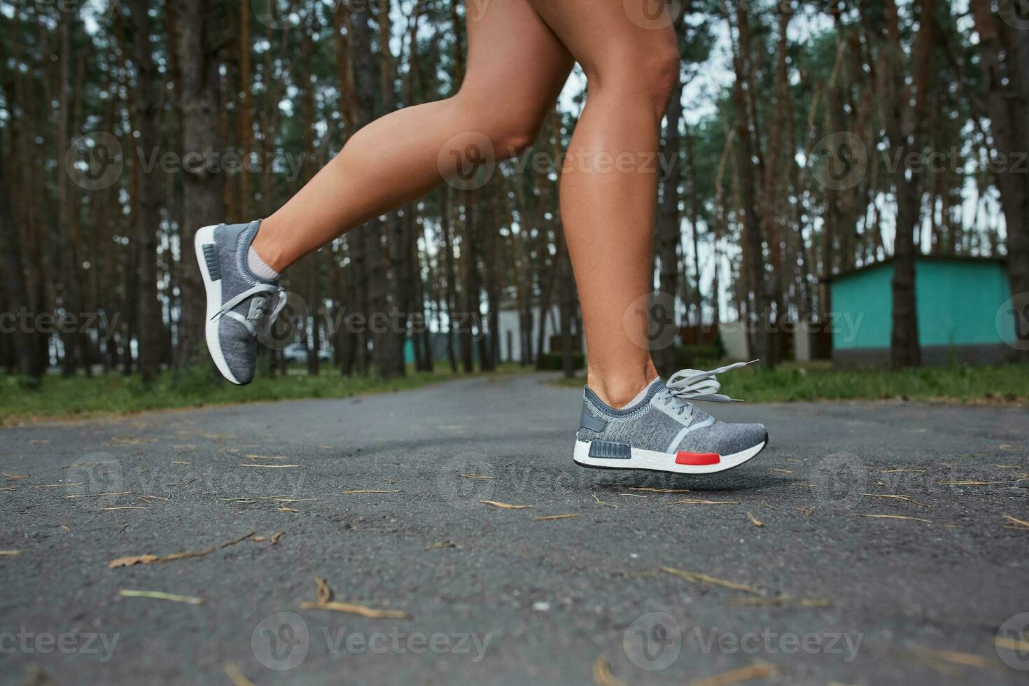 Young woman running outdoors in a city park photo