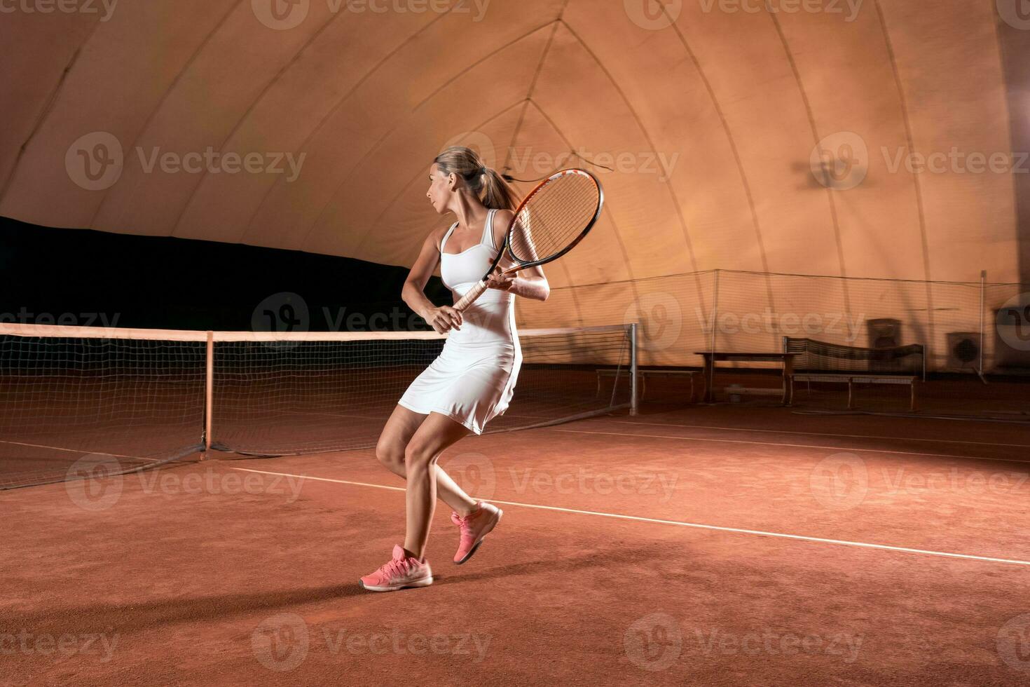 young sportswoman playing tennis photo