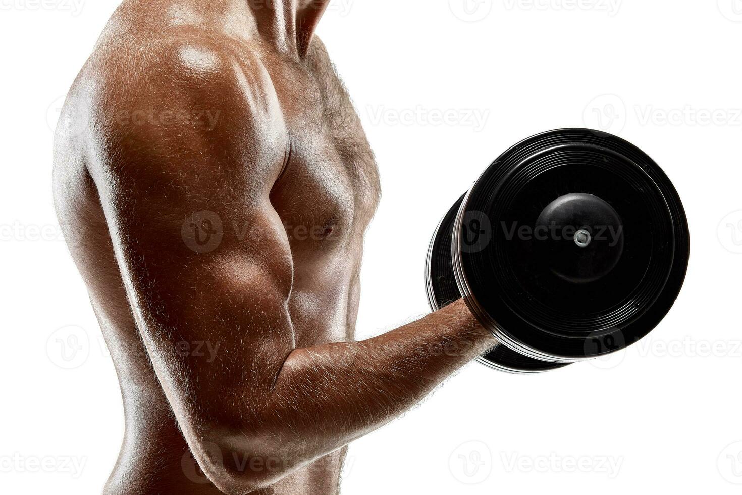 Handsome muscular man with bare chest lifting dumbbell, studio shot on white background photo