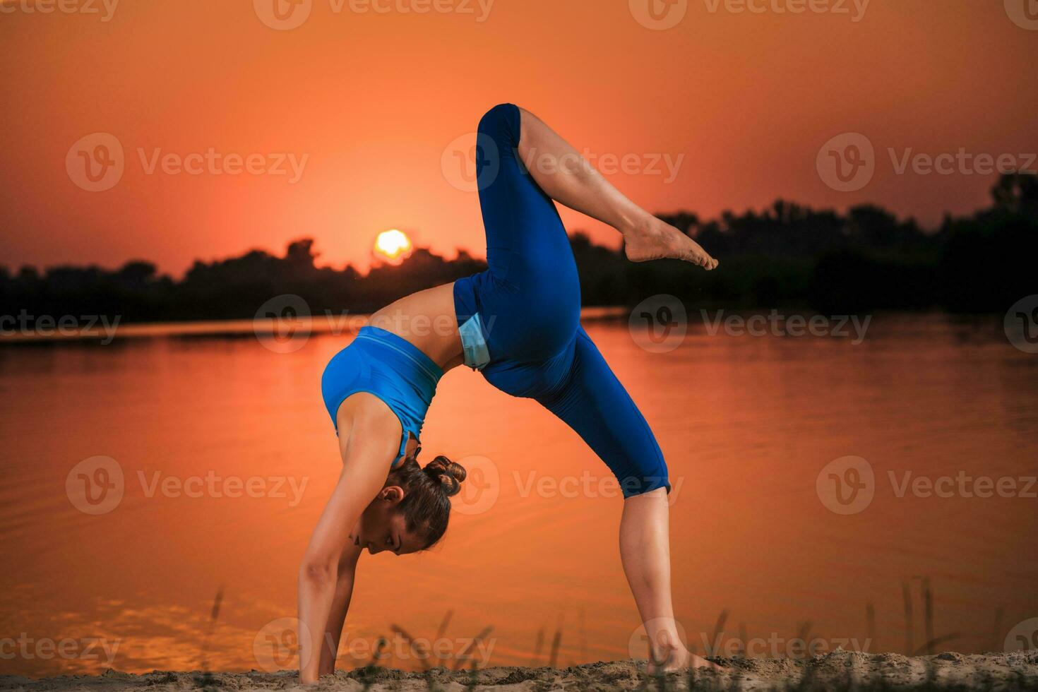 yoga at sunset on the beach. photo