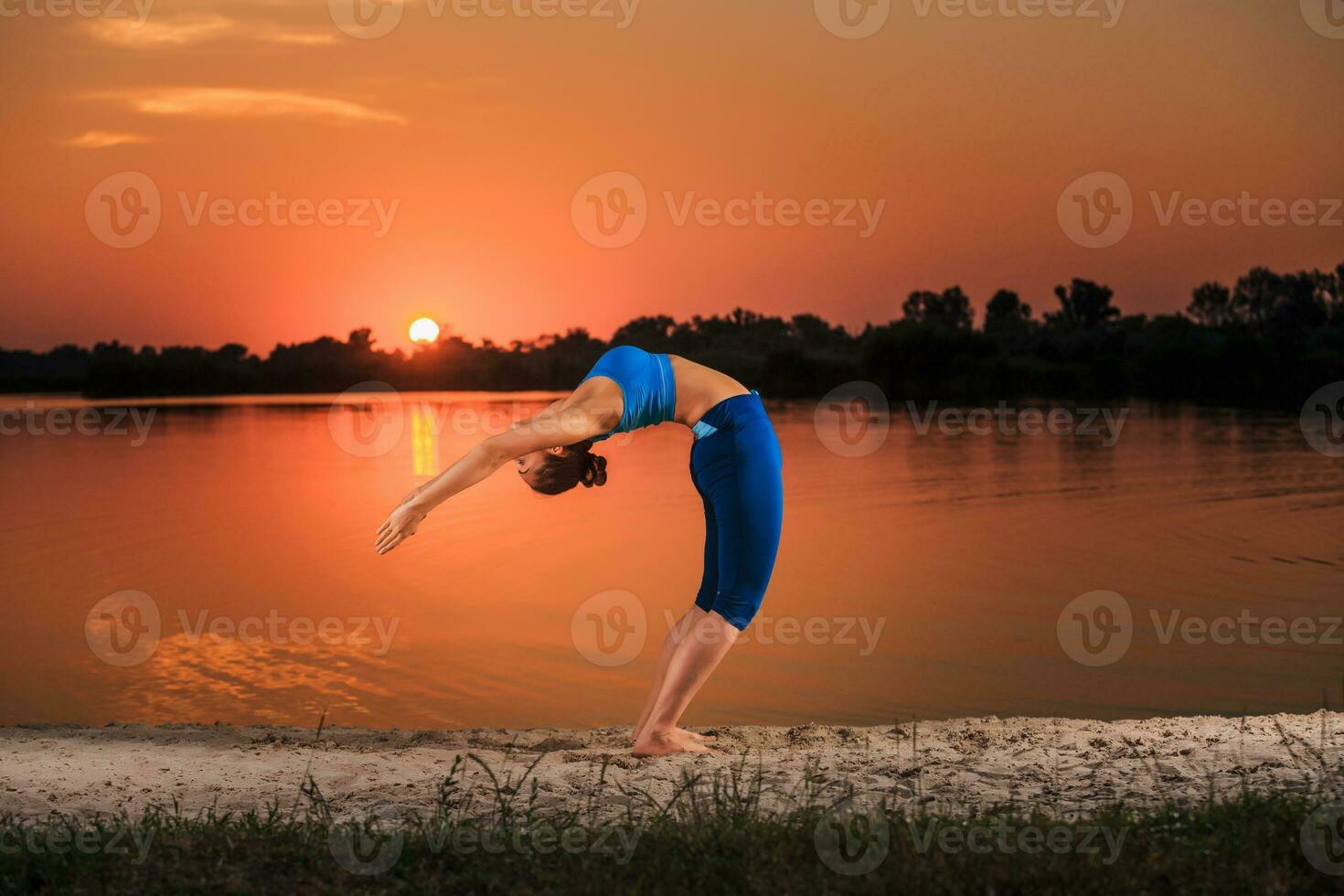yoga at sunset on the beach. photo