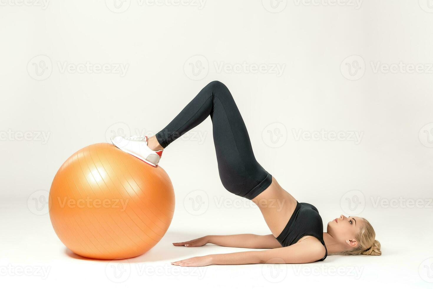 Young woman training with fitball photo