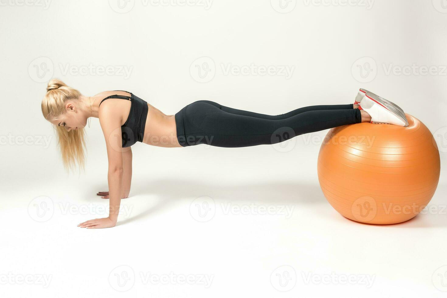 Young woman training with fitball photo