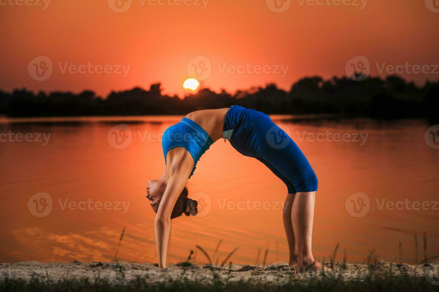 yoga at sunset on the beach. photo