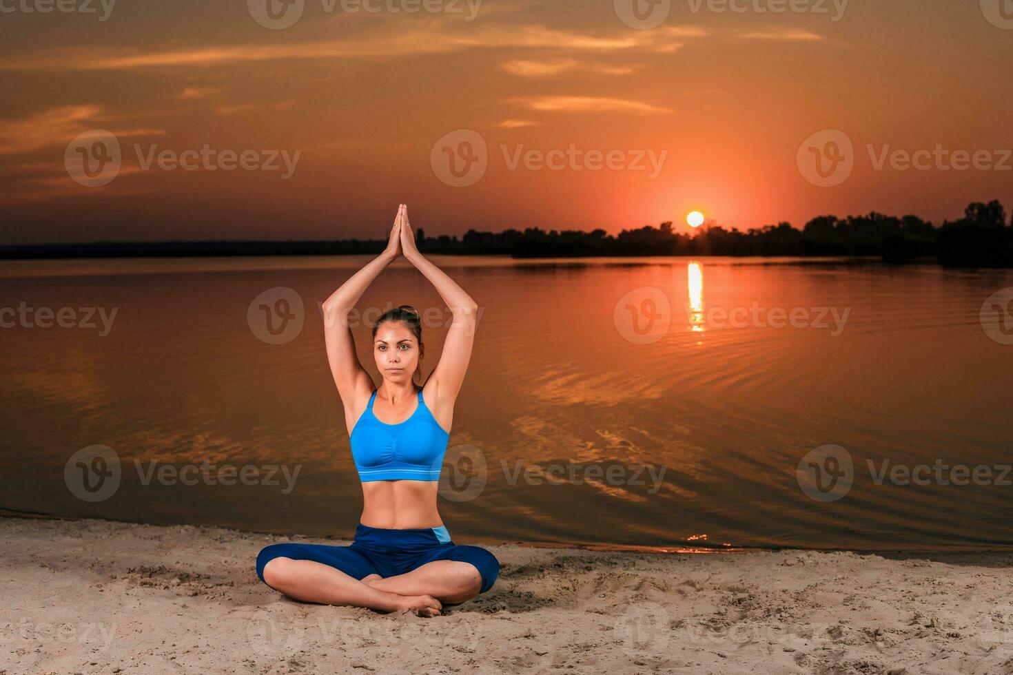 yoga at sunset on the beach. photo