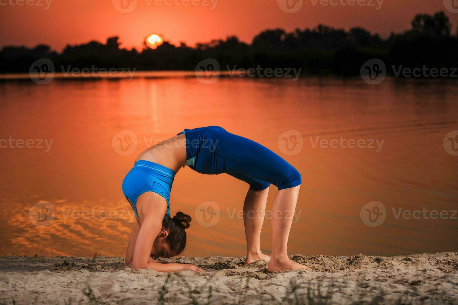 yoga at sunset on the beach. photo