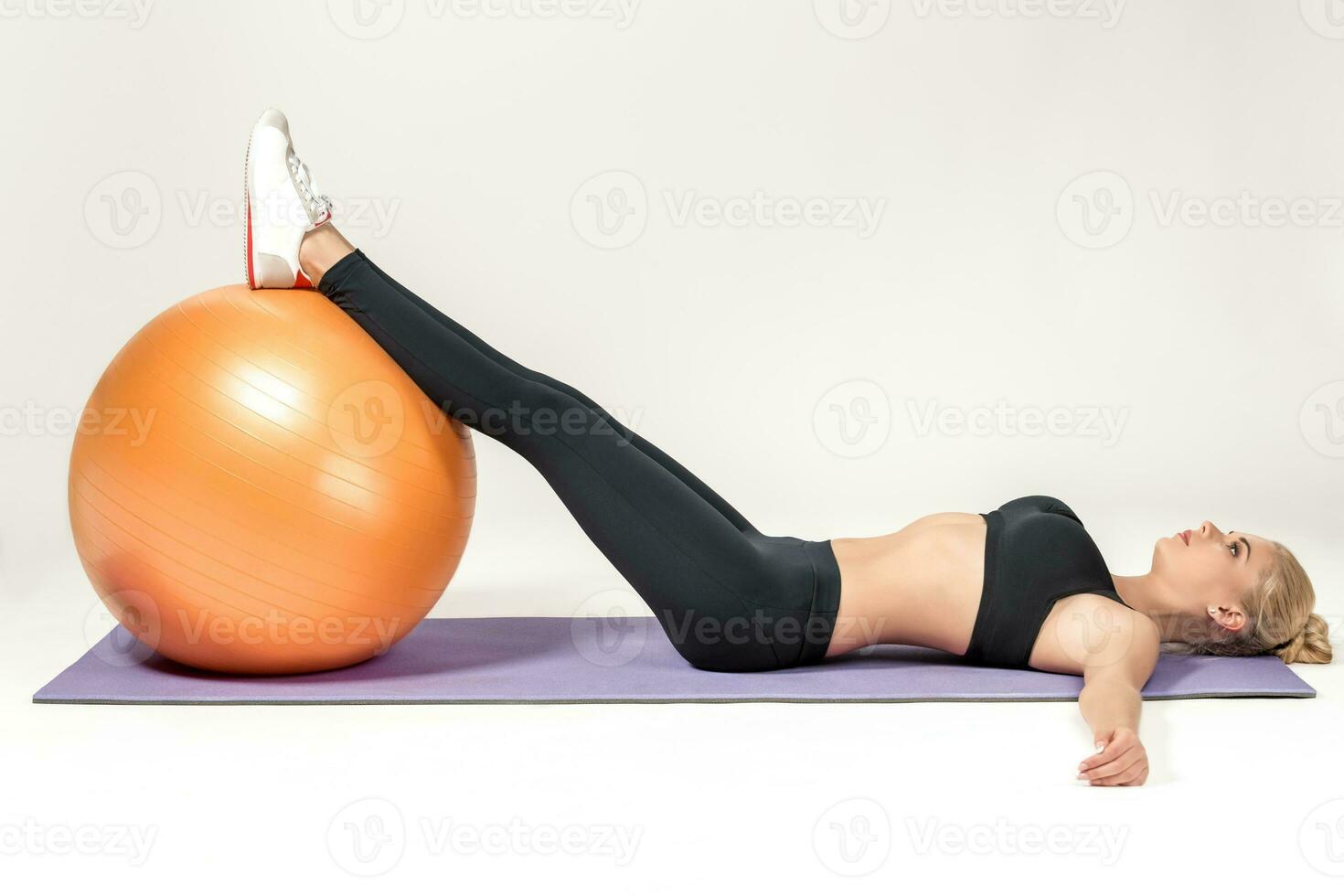 Young woman training with fitball photo