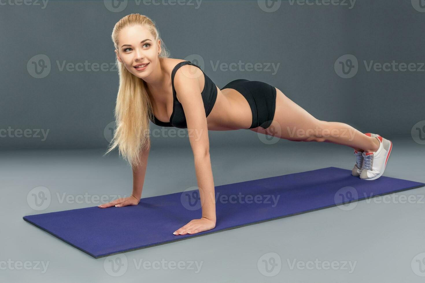 Young beautiful woman in fitness wear trained female body photo