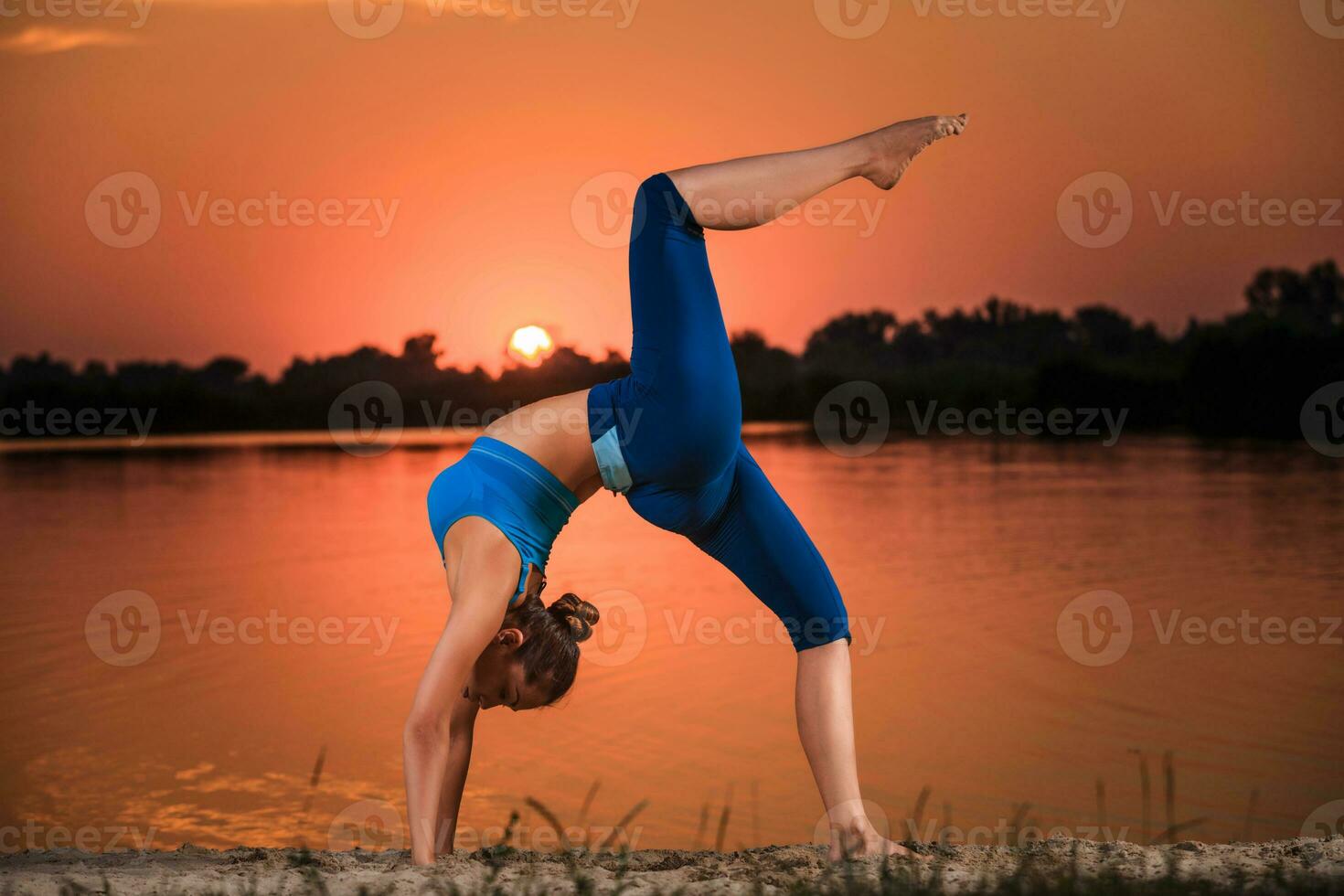 yoga at sunset on the beach. photo