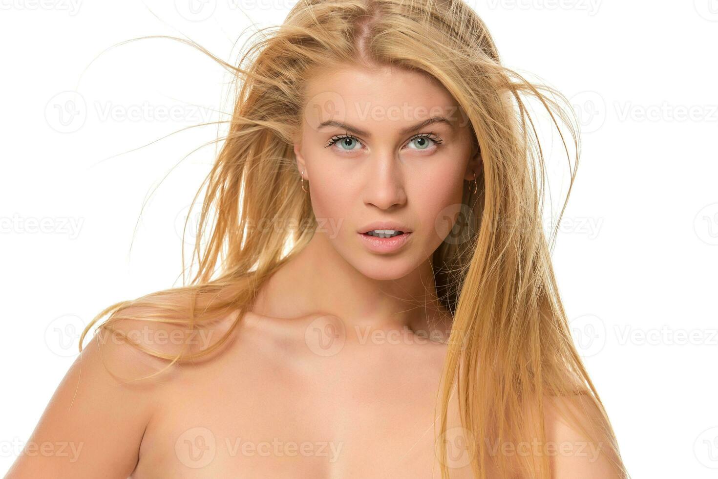 Young blond woman looking at the camera. Closeup photo