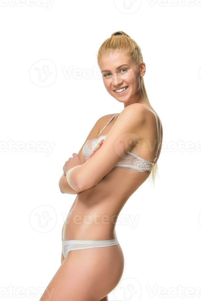 Young blonde woman in white underwear, studio photo