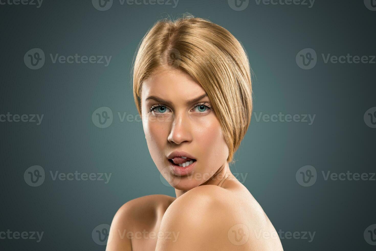 Portrait beautiful blond woman with long hair and blue eyes photo