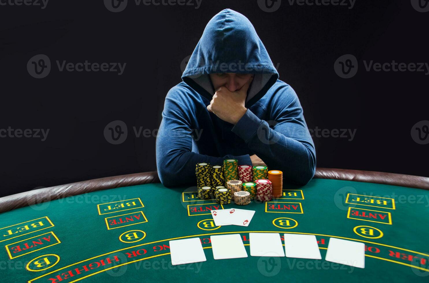 Portrait of a professional poker player sitting at pokers table photo