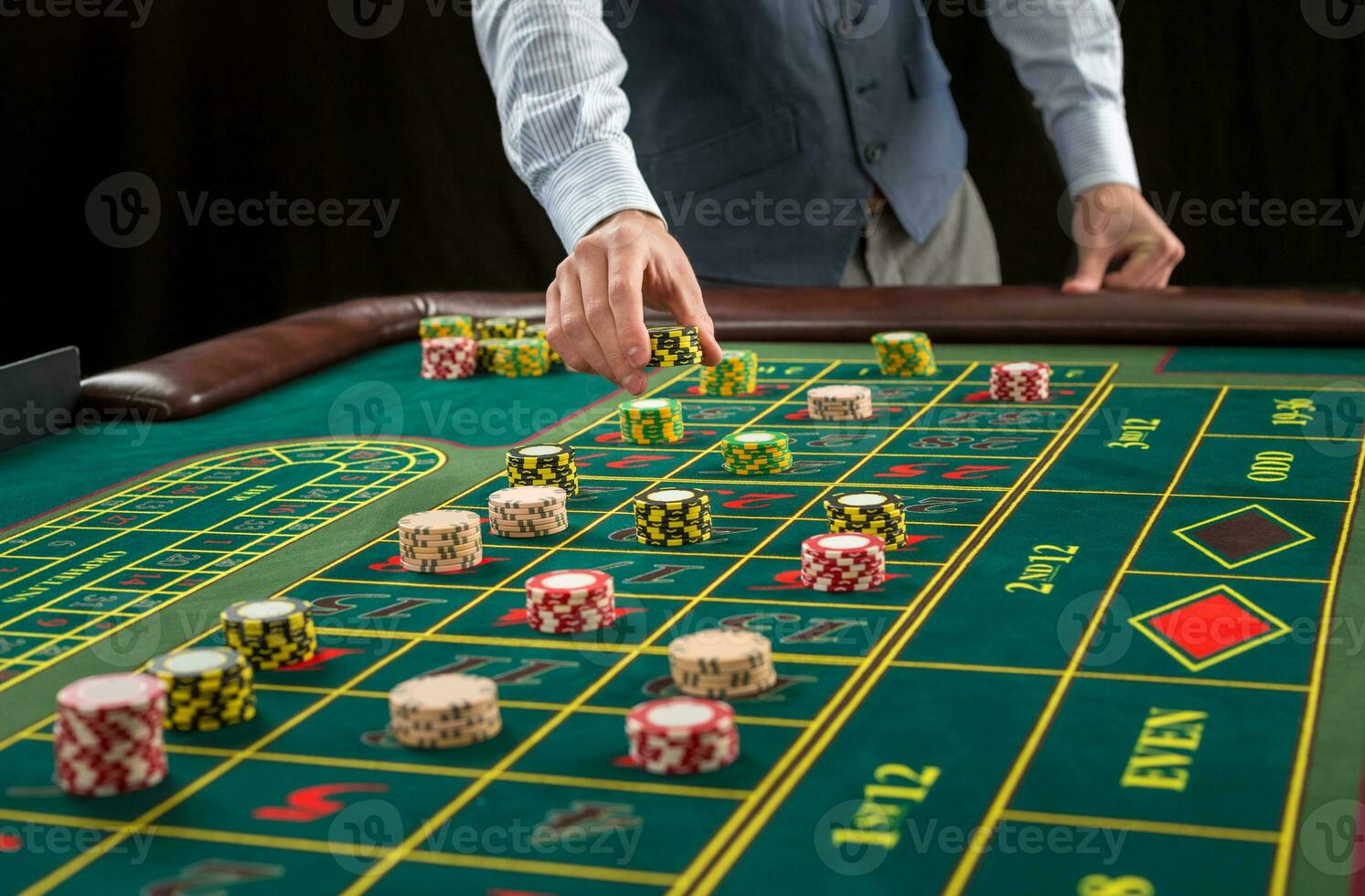 Picture of a green table and betting with chips. photo