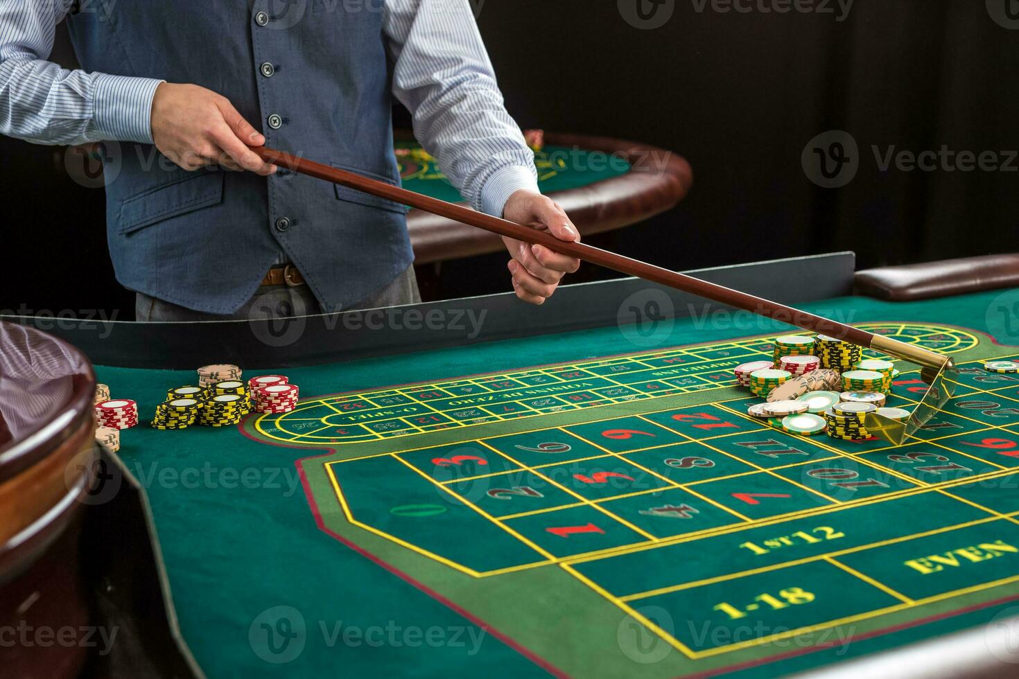 Roulette and piles of gambling chips on a green table. photo