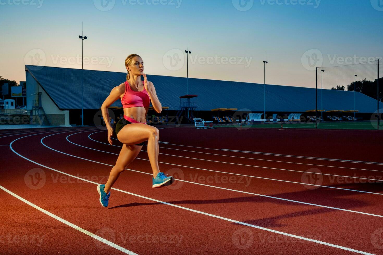 Runner sprinting towards success on run path running athletic track. Goal achievement concept. photo