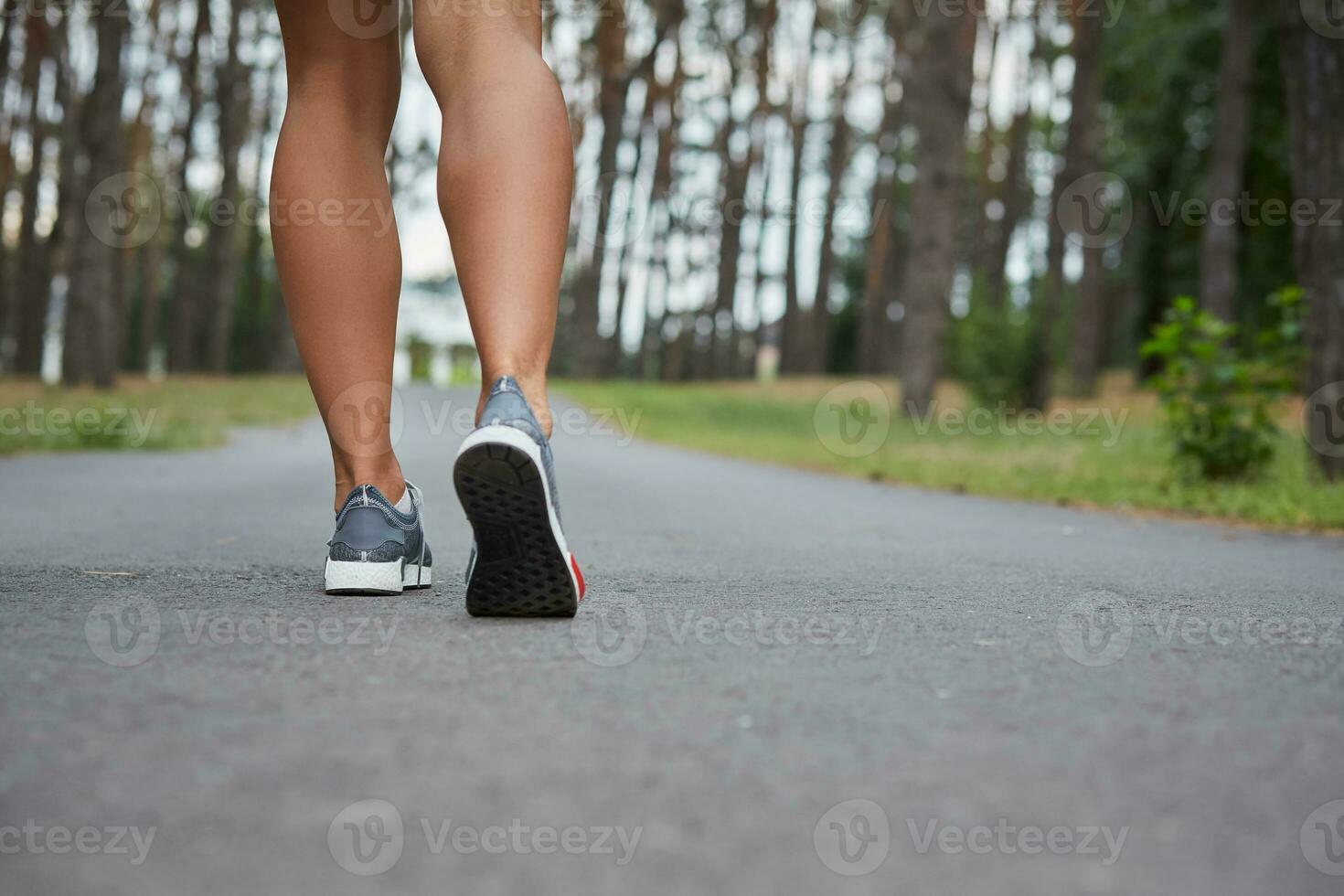 Young woman running outdoors in a city park photo