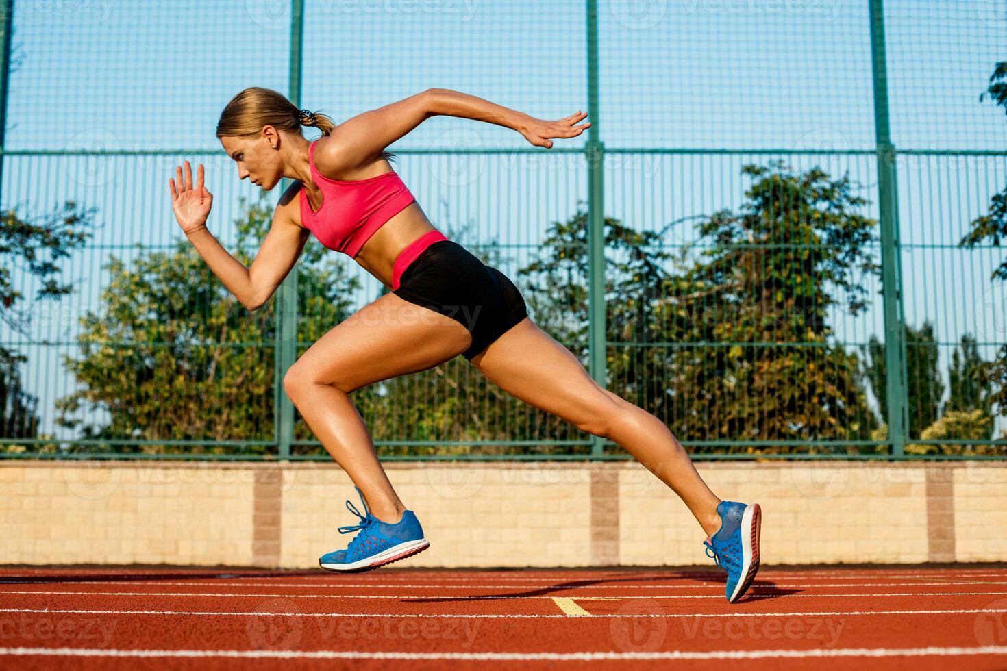 Runner sprinting towards success on run path running athletic track. Goal achievement concept. photo