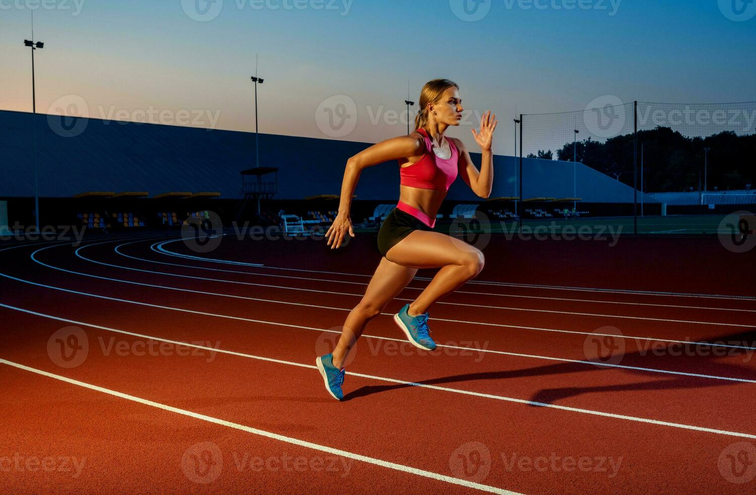 Runner sprinting towards success on run path running athletic track. Goal achievement concept. photo
