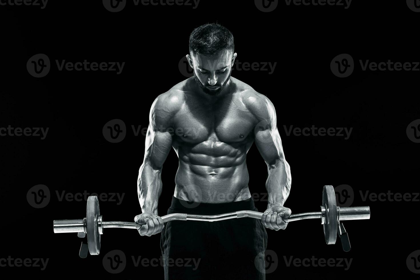 muscular man lifting weights over dark background photo