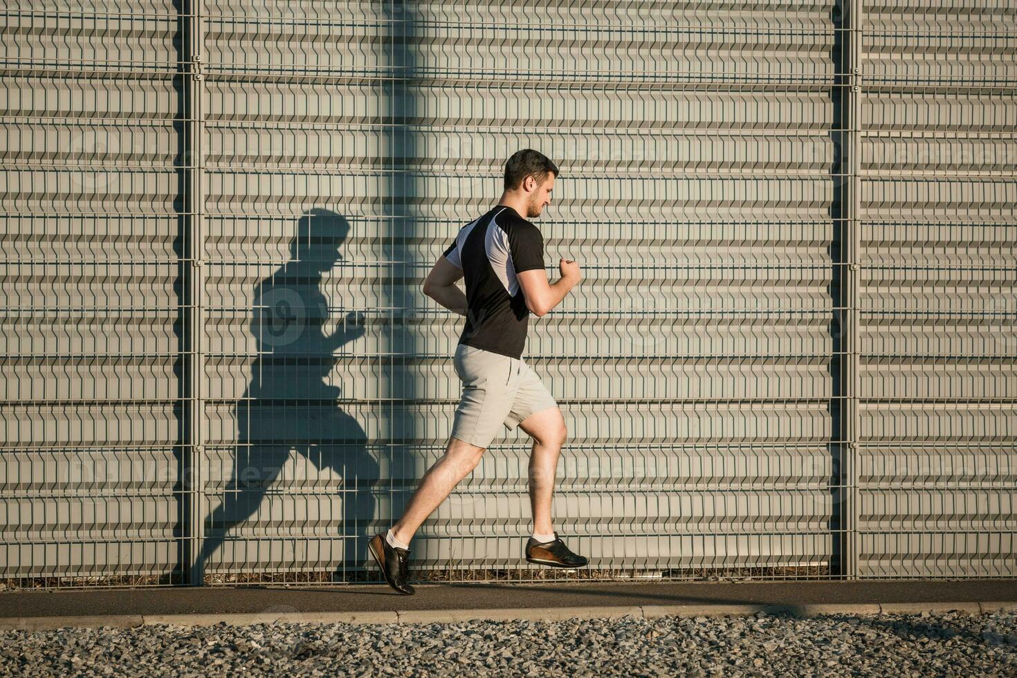 Full length portrait of athletic man running photo