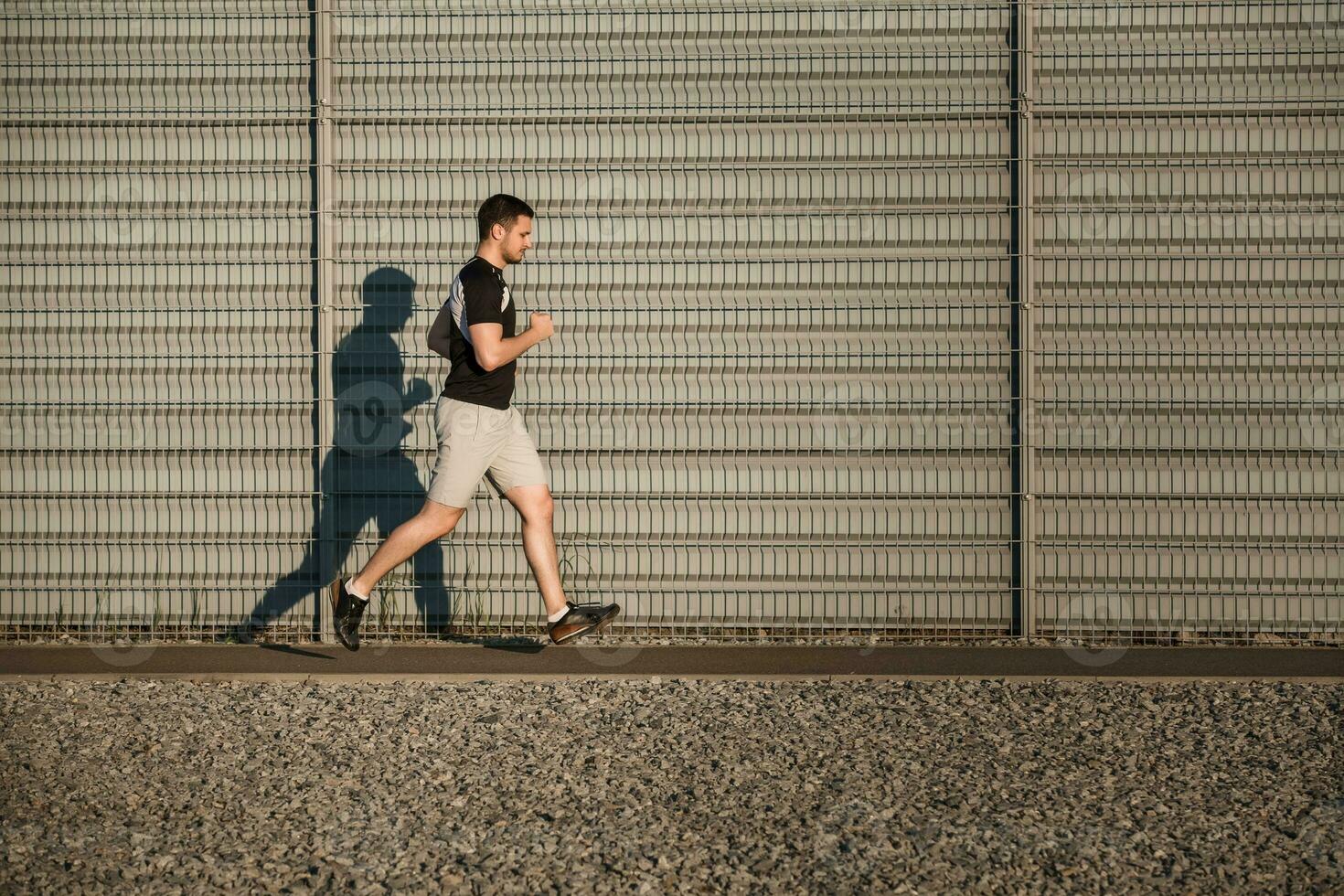 Full length portrait of athletic man running photo