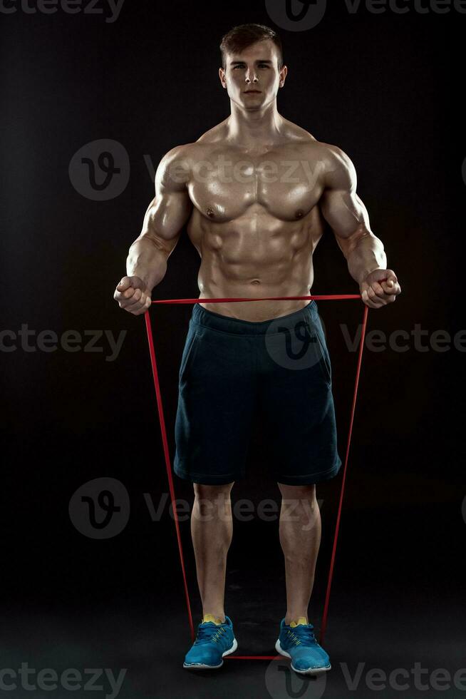 Young athletic man exercising and doing fitness photo