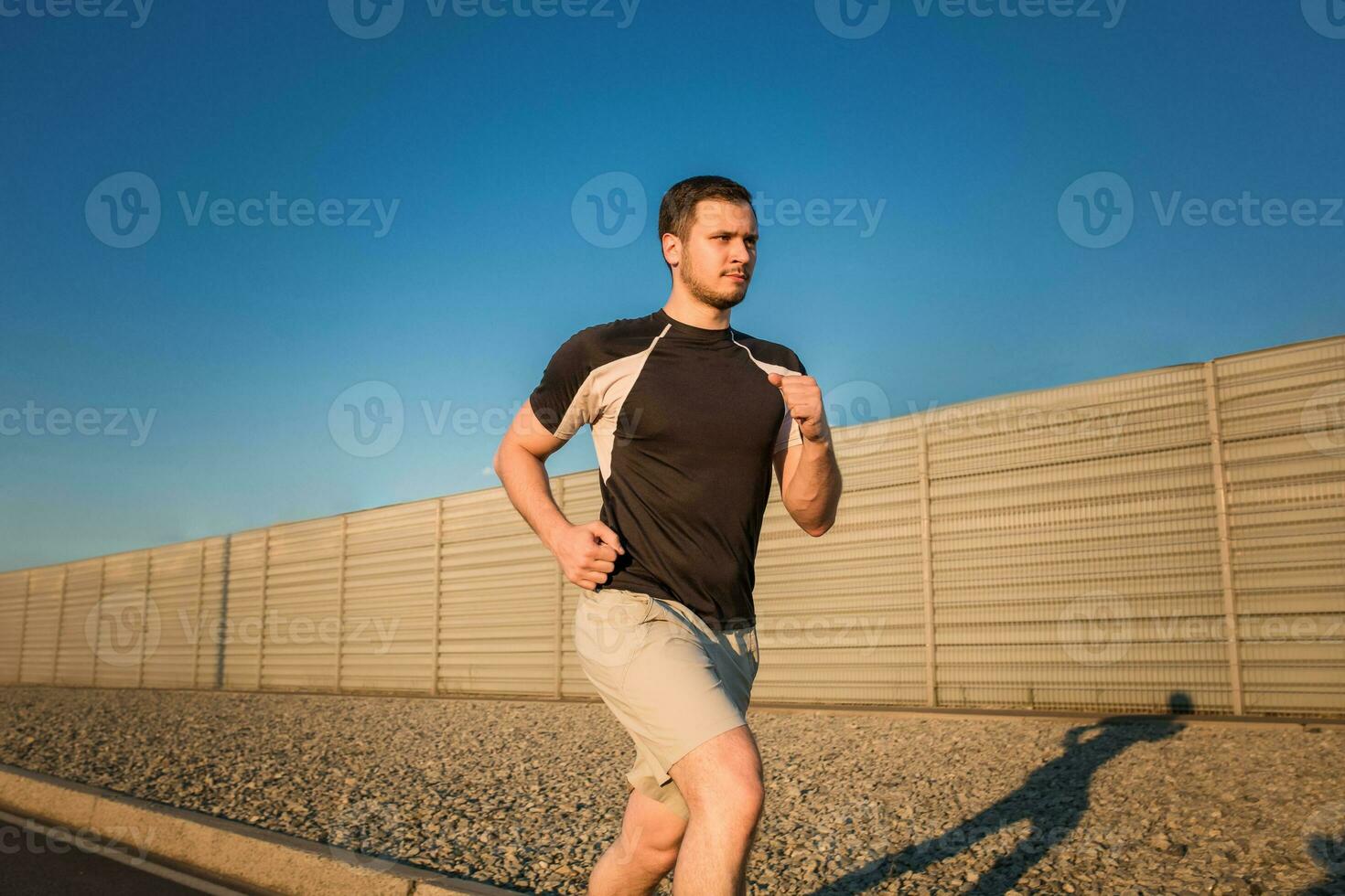 Close-up portrait of athletic man running photo