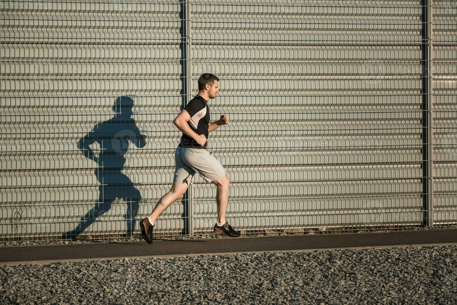 Full length portrait of athletic man running photo