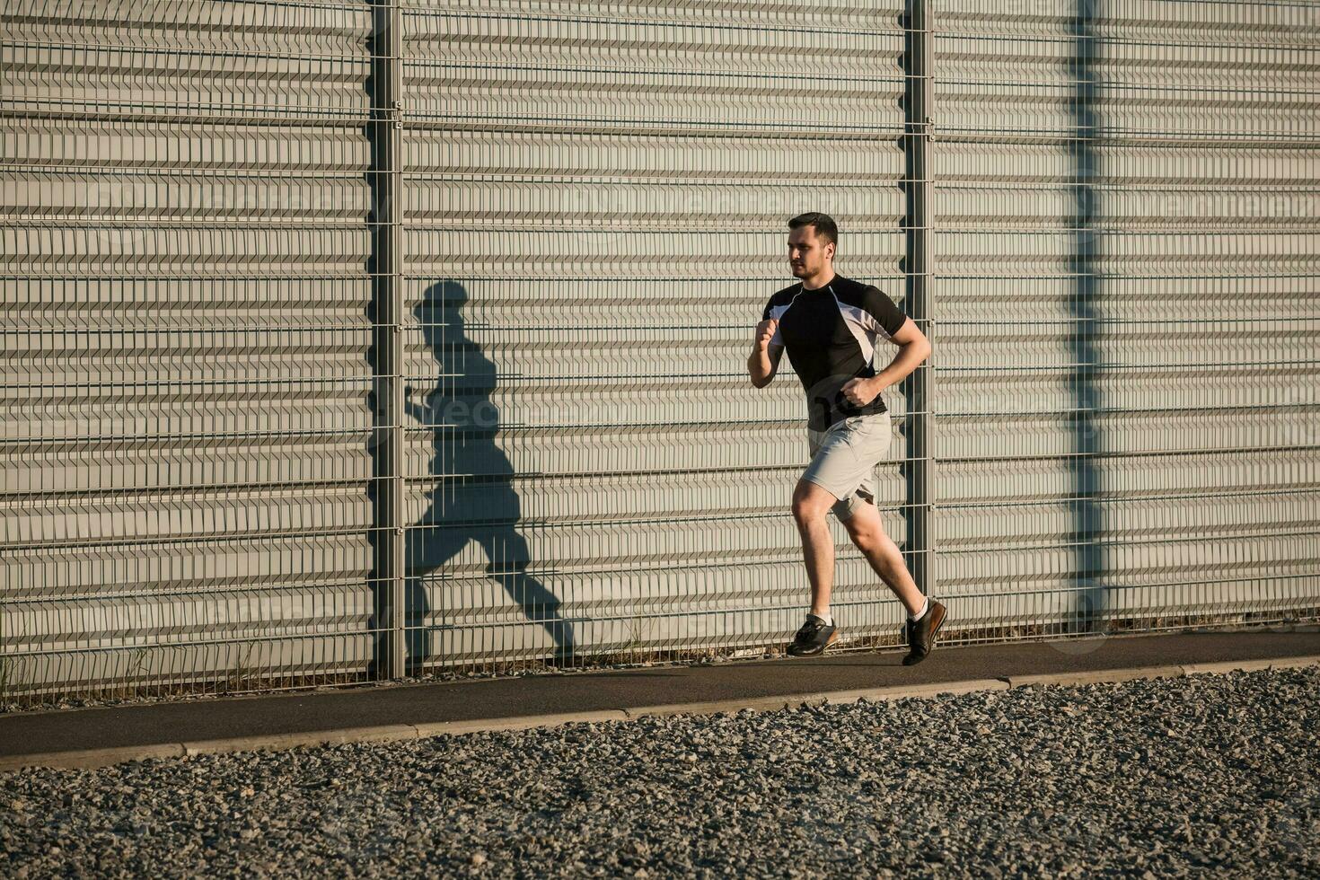 Full length portrait of athletic man running photo