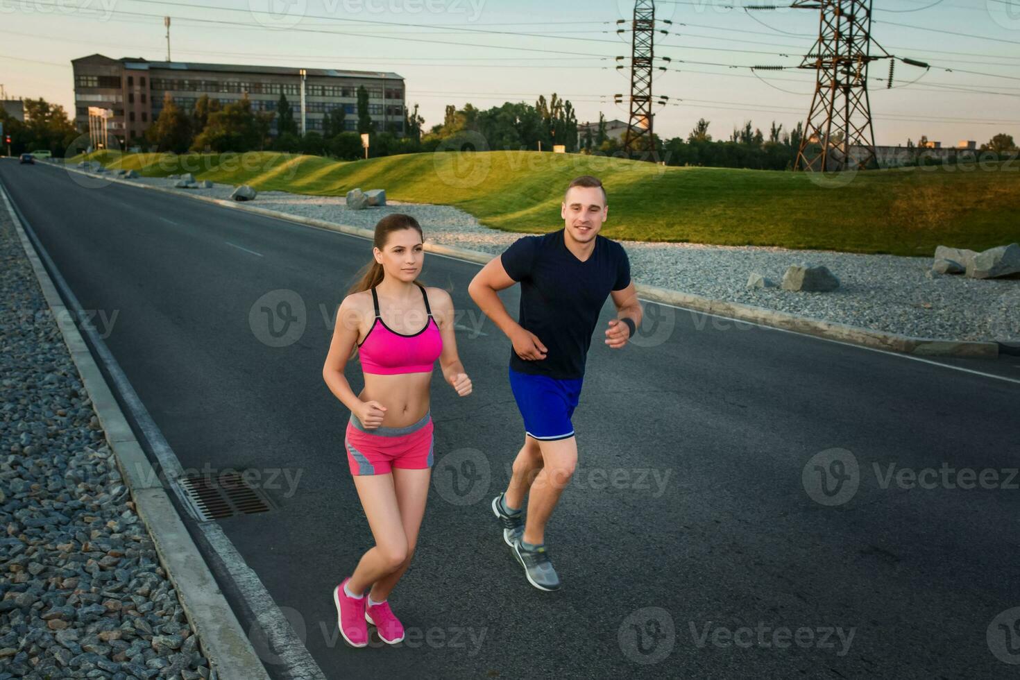 Full length portrait of athletic couple running photo