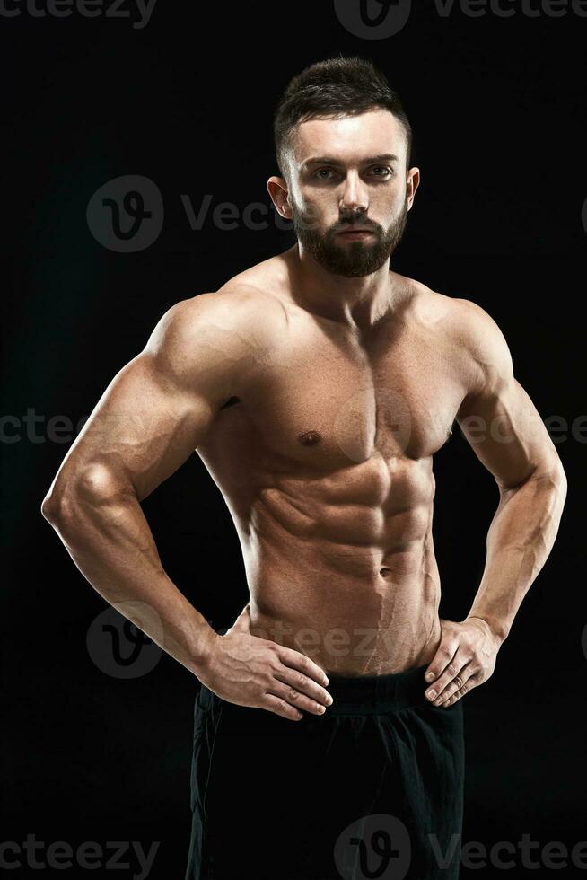 Muscular bodybuilder guy doing posing photo