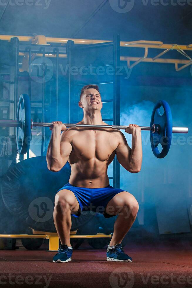 man doing exercises with barbell photo