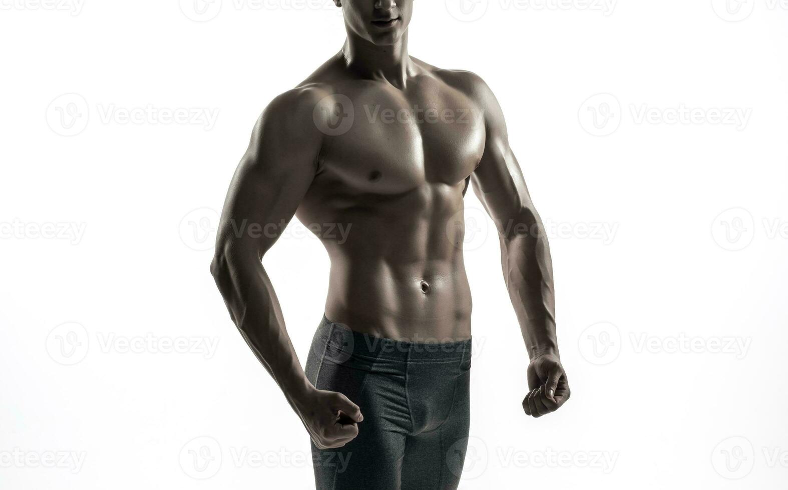 Bodybuilder man posing, showing perfect abs, houlders, biceps, triceps, chest photo