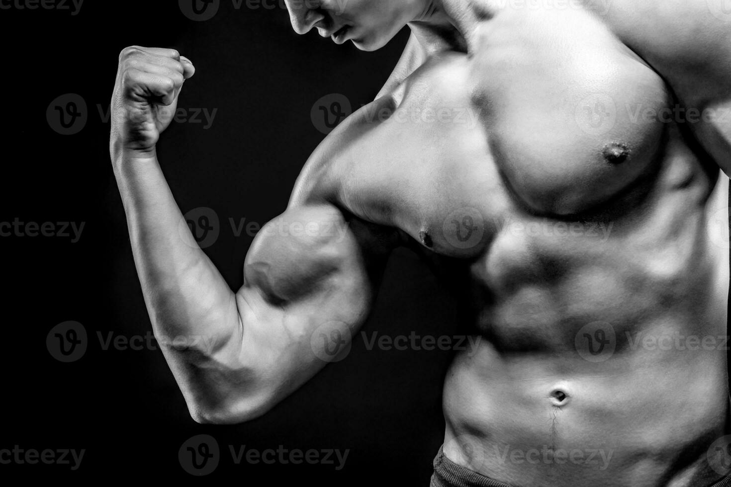 Image of very muscular man posing with naked torso photo