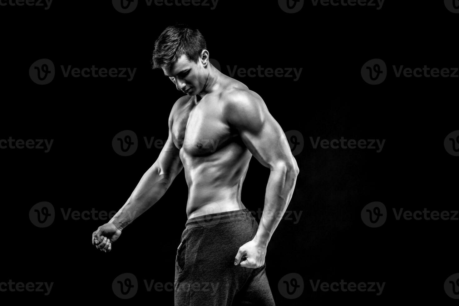 Image of very muscular man posing with naked torso photo
