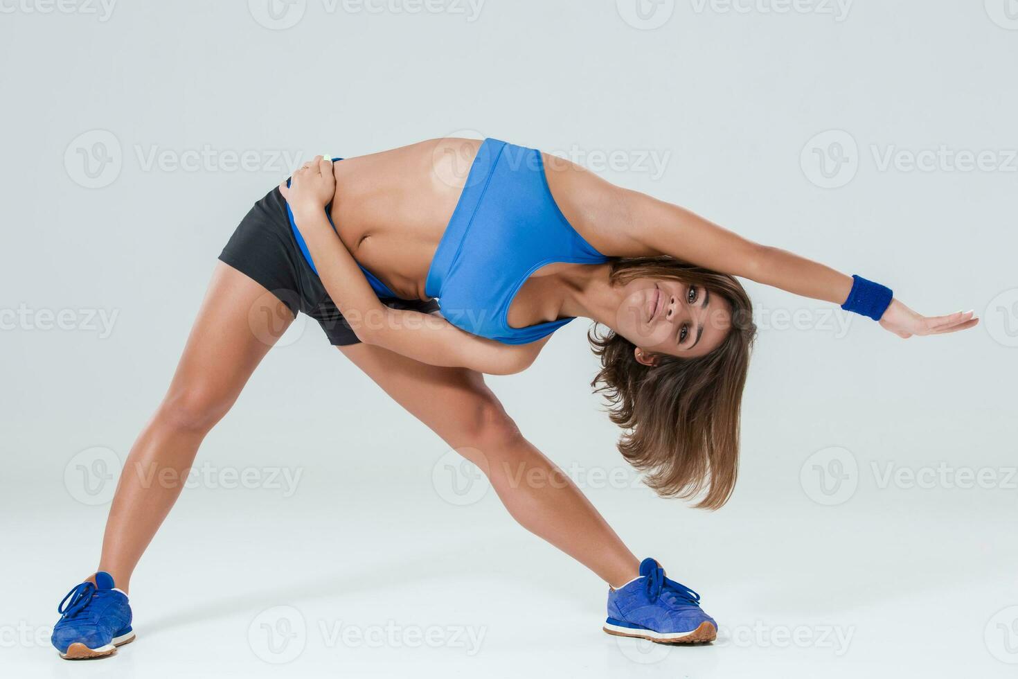 Sporty flexible girl doing stretching exercise photo